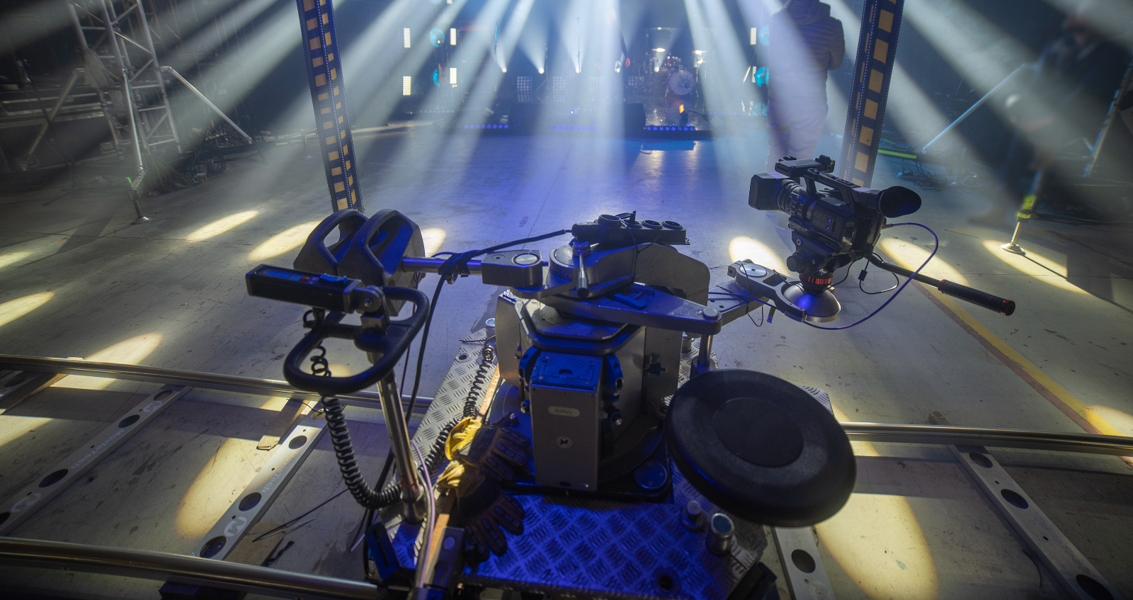 A camera dolly system ready to film a dimly light